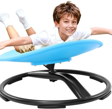 Smiling boy playing on a blue sensory swivel chair for kids balance and coordination training.