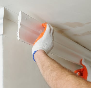 a man is painting a ceiling with a paint job