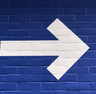 White arrow pointing right, symbolizing direction.