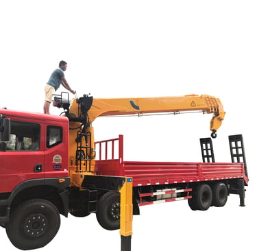 A man standing on top of a 14 ton Telescopic Boom Truck Mounted Crane with 4 section arms.