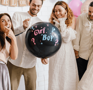 a group of people standing around a balloon - shaped balloon