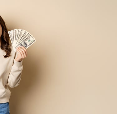 A happy woman cheering and holding a fan of hundred dollar bills representing financial success and cash earnings.