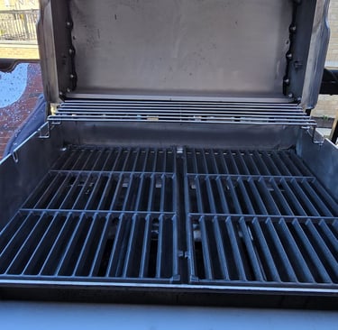 Close-up of professionally cleaned BBQ grill grates showing spotless finish