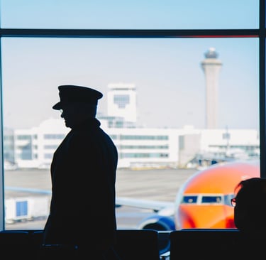 a man in a uniform is standing in front of a window