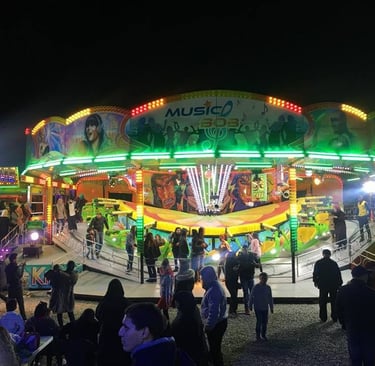 Agadir carnival ride at night time with people walking around