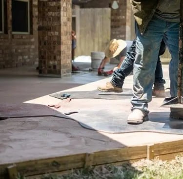 men working on a concrete patio