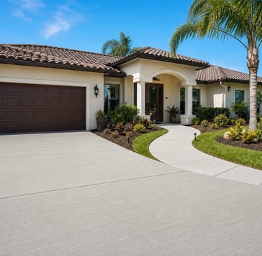 a modern Florida home featuring a beautifully upgraded broom-finished concrete driveway and curved walkway.
