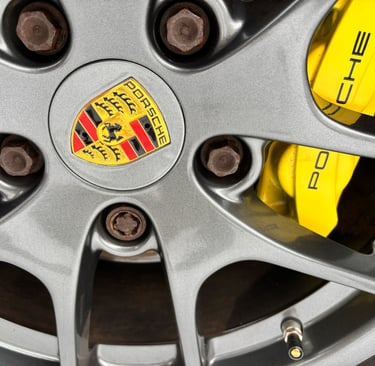 pristine Porsche wheel with bright yellow calliper