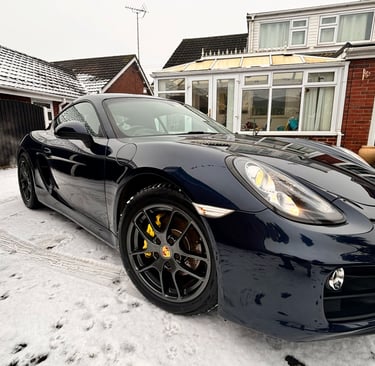 a pristine black Porsche sports car