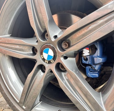 a car wheel with a blue calliper