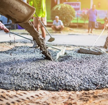 construction workers are pouring concrete mix
