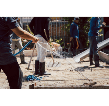men working on a concrete foundation pouring