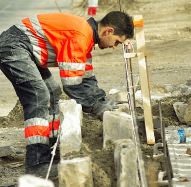 a man in a safety vest is working on a construction site