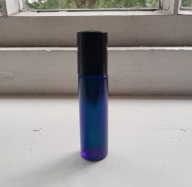 An image of a homemade aromatherapy perfume called Roller Ball Pulse Point in a blue spray bottle.