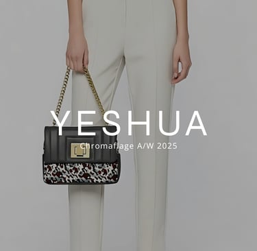 a woman in a white top and pants with a black purse