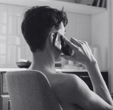 A man talking to a women he is dating on the phone rather than texting her.