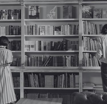 a single man and a single woman looking at books at a bookshop