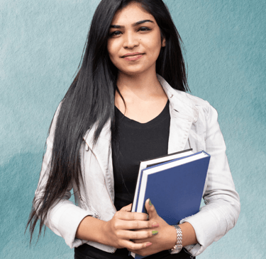 "Teacher standing with books in hand, ready to guide students in their learning."