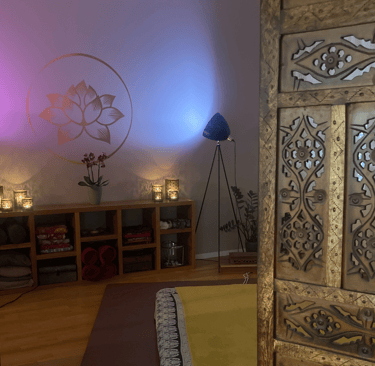 a massage space with a futon on the floor and candles
