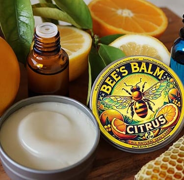 Bee's Balm Citrus Scent surrounded by beeswax and citrus fruit and essential oils