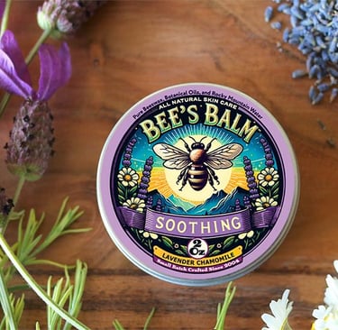 Tin of Bee's Balm Soothing - Lavender Chamomile - salve surrounded by lavender & chamomile flowers
