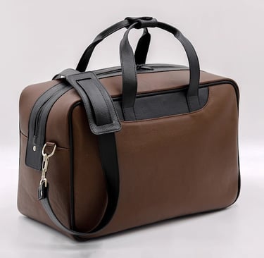 a brown and black bag with a keychaik