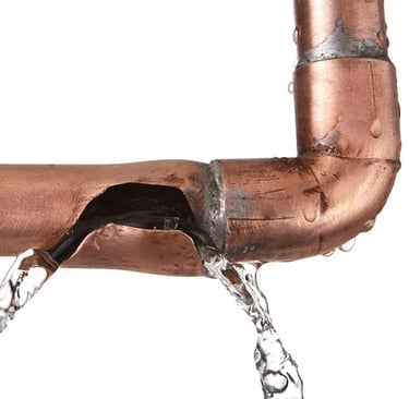 "Close-up of a leaking pipe showing hidden risks when seasonal homes are left unwatched in coastal M