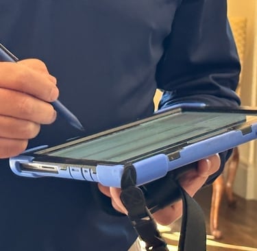 "Person using a tablet during a home visit, highlighting the difference between inspection and home 