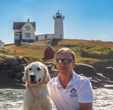 “Golden retriever sitting near Nubble Lighthouse in York, Maine, symbolizing trust and peace of mind