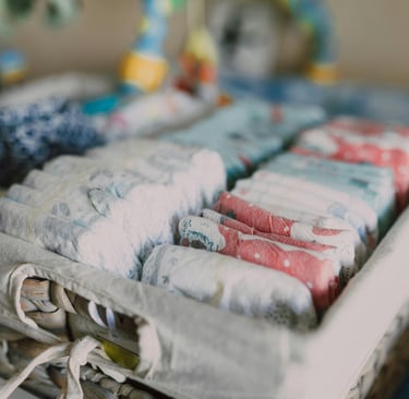 Diaper changing setup with wipes, cream, and diapers in an organizer