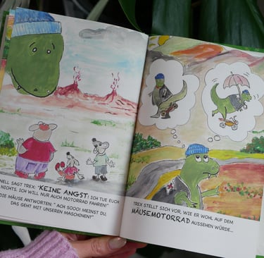 a person holding a book with a picture of a dinosaur