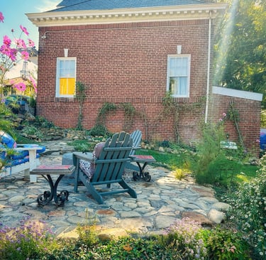 brick carriage house and stone patio with adirondack chairs 2123 rivermont