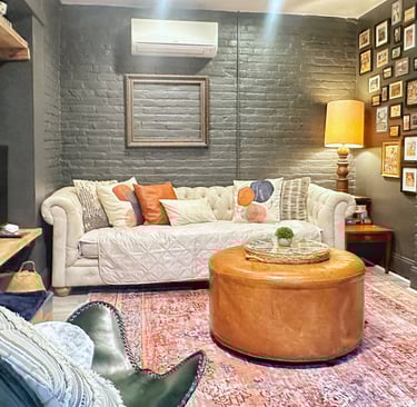 Guest nest apartment 2123 rivermont living room with white couch and gray brick walls