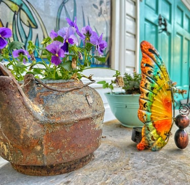 detail of old kettle with flowers growing inside 2123 rivermont