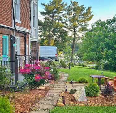 a garden with a bench and a table
