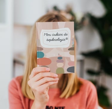 a woman holding up a book with a notepad