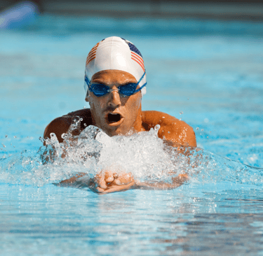 a swimmer in a swimming pool with a usa flag on his head