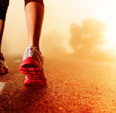 a person walking on a road with a red shoe