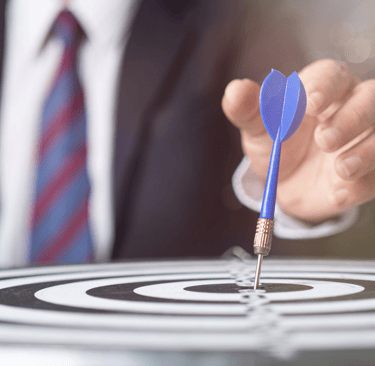 a man in a suit and tie is holding a dart dart dart in the center