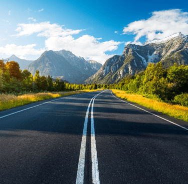 a road with a mountain in the background