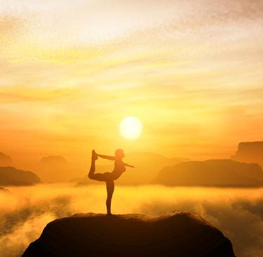 a person doing yoga on a mountain top