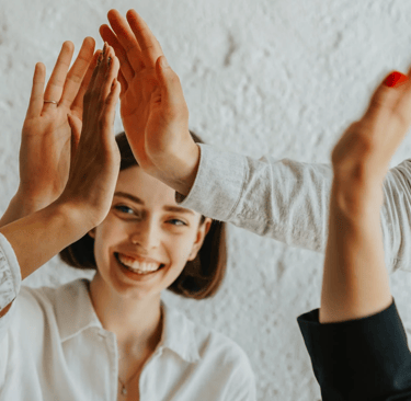 a woman is giving a high five finger sign