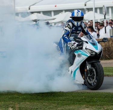 A biker doing a burnout at Goodwood