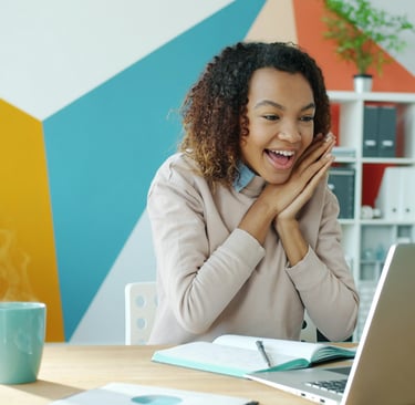 Happy student looking at laptop representing academic success and effective career counseling