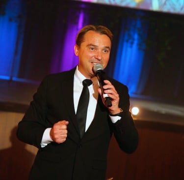Professional fundraising emcee Craig Rosie capturing room energy during a California gala.