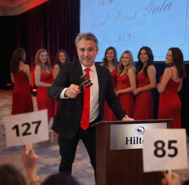 Professional fundraising auctioneer Craig Rosevear using a gavel at the podium to take live bids fro