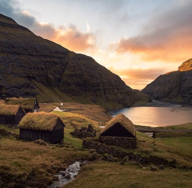 Saksun village at sunset – turf-roof houses and golden light on the lagoon in the Faroe Islands