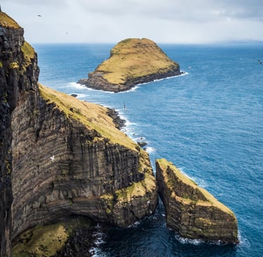 Basalt sea stacks and sheer cliff face near Skopun, textured rock and wild Atlantic scenery, Faroe Islands seascape