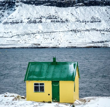 Snow-covered Faroese yellow house in winter — March photography workshop location