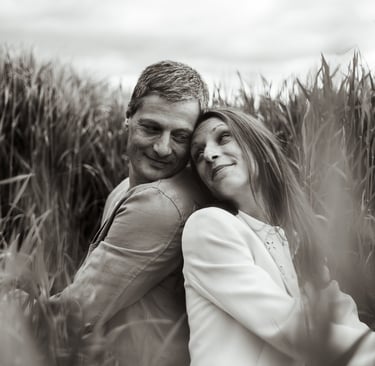 a man and woman are hugging in a field